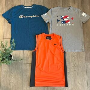 ((3 PIECE)) BOYS ATHLETIC TEE BUNDLE SIZE MEDIUM NIKE UNDER ARMOUR AND CHAMPION